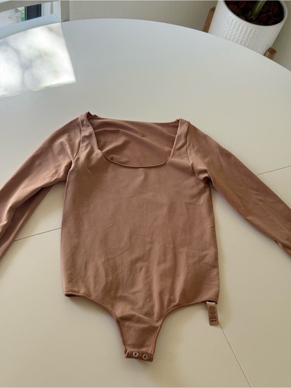 SKIMS Kids Long-Sleeve One-Piece Bodysuit in Mauve